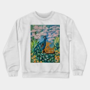 A peacock sitting on a gate in n a garden with flowers and cherry blossoms around it . Crewneck Sweatshirt